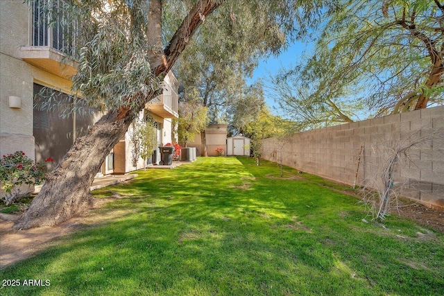 view of yard featuring a storage shed and central air condition unit