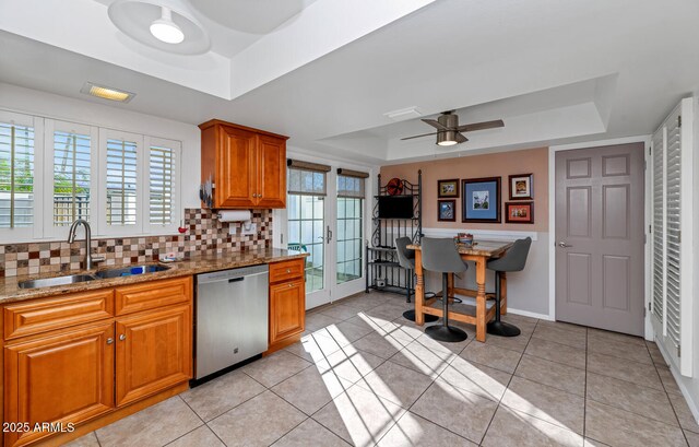 kitchen featuring dishwasher, french doors, sink, light tile patterned floors, and a tray ceiling