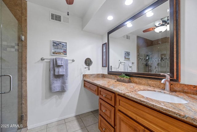 bathroom featuring tile patterned floors, vanity, ceiling fan, and a shower with shower door