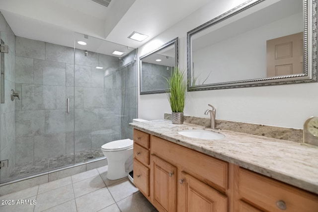 bathroom with toilet, vanity, tile patterned floors, and an enclosed shower