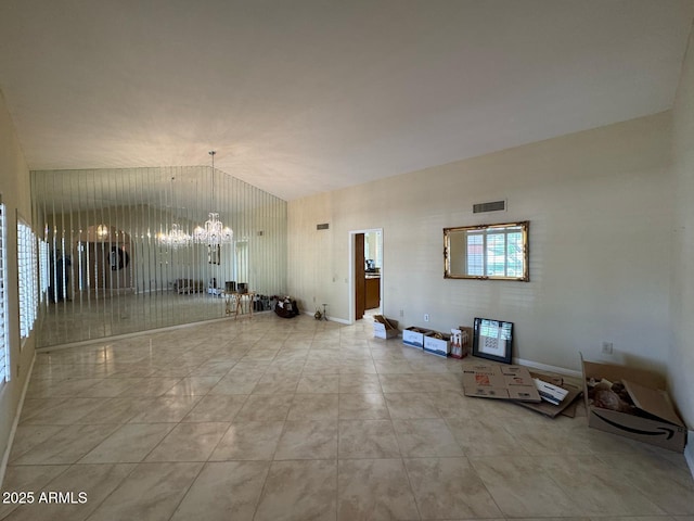 unfurnished living room featuring visible vents, a chandelier, and vaulted ceiling