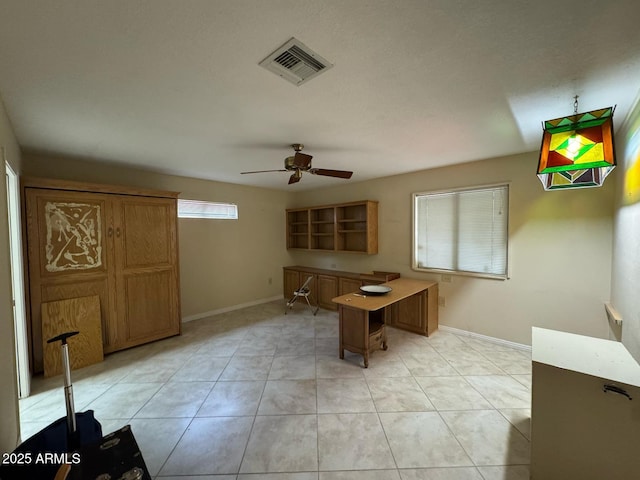 interior space with light tile patterned floors, baseboards, a ceiling fan, and visible vents