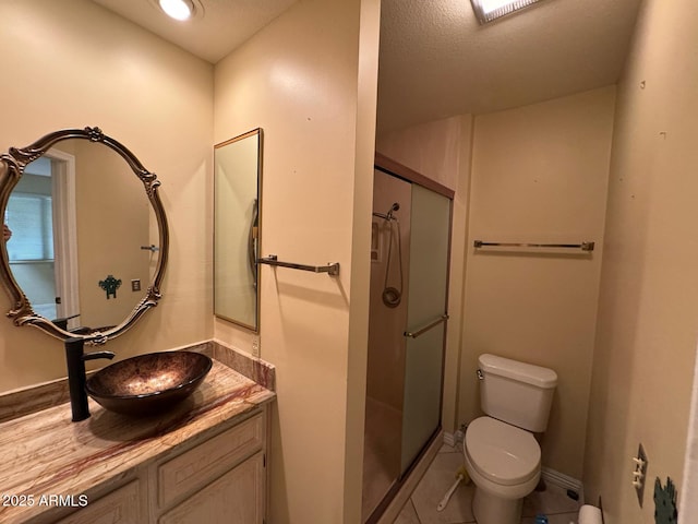 full bath with vanity, toilet, baseboards, tile patterned floors, and a stall shower