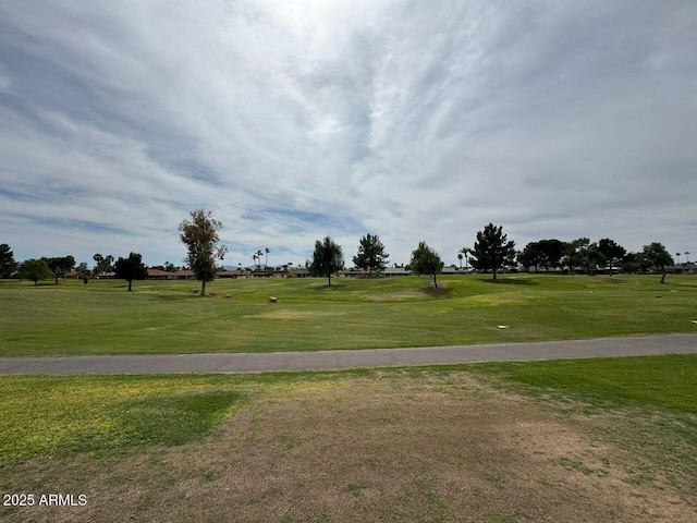 exterior space with a lawn and view of golf course