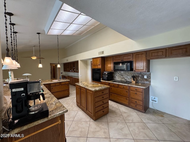 kitchen with a center island, lofted ceiling, tasteful backsplash, visible vents, and black appliances