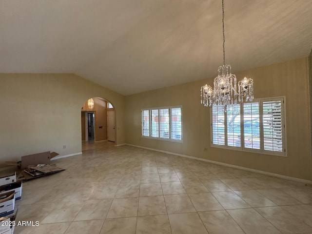 unfurnished dining area with arched walkways, vaulted ceiling, baseboards, tile patterned floors, and a chandelier