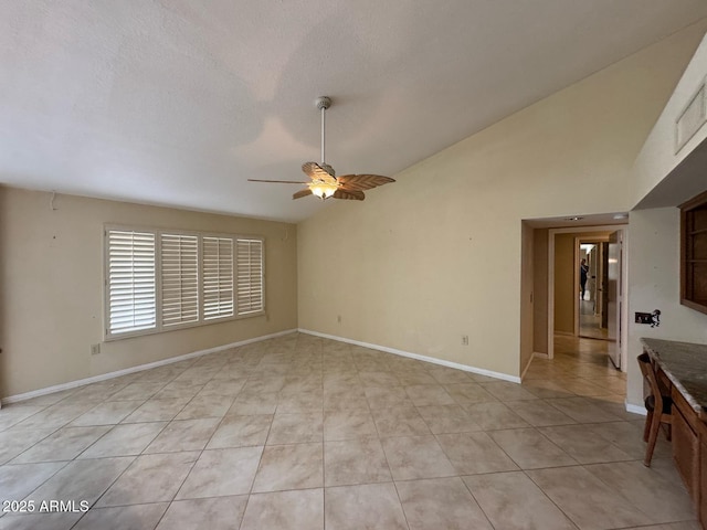unfurnished living room with light tile patterned flooring, ceiling fan, baseboards, and a textured ceiling