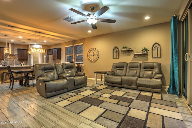 living room featuring wood-type flooring and ceiling fan