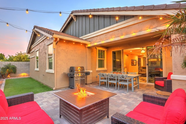 exterior space featuring an outdoor living space with a fire pit and grilling area