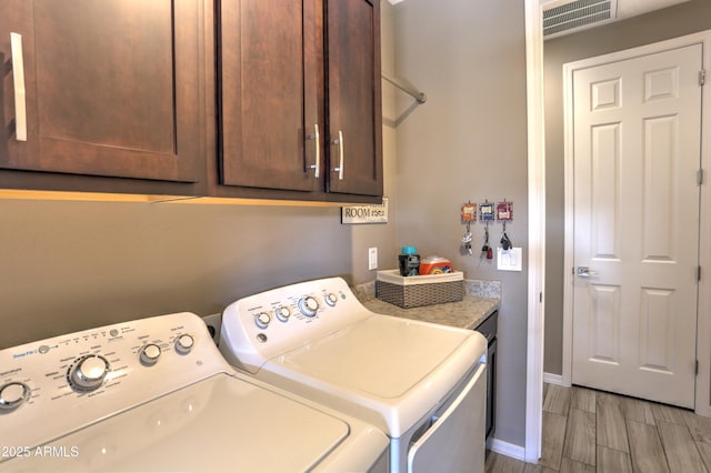 washroom with cabinets and independent washer and dryer