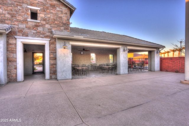 patio terrace at dusk with a fireplace