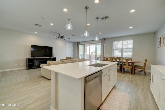 kitchen featuring a sink, visible vents, white cabinets, and dishwasher