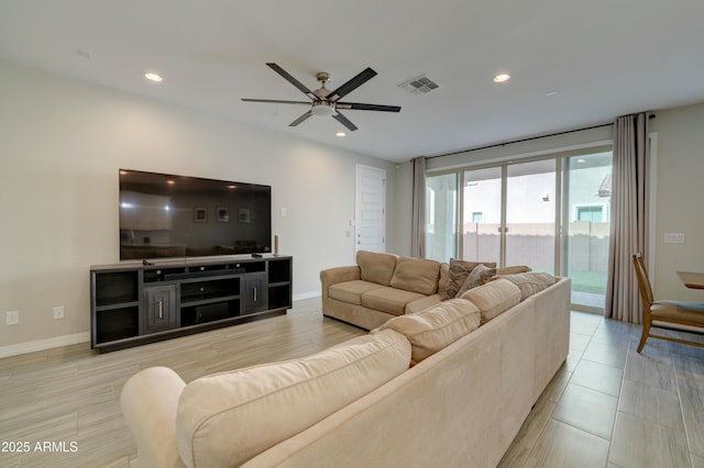 living area featuring ceiling fan, baseboards, visible vents, and recessed lighting