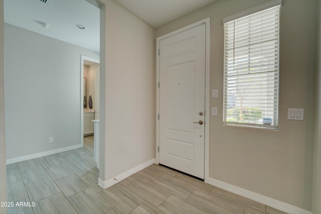 foyer featuring baseboards