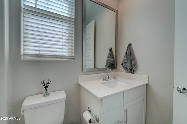 half bathroom featuring toilet and vanity