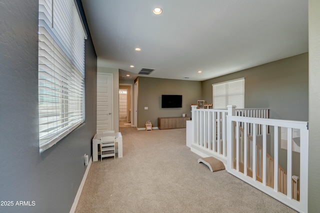 corridor featuring recessed lighting, carpet, visible vents, and an upstairs landing