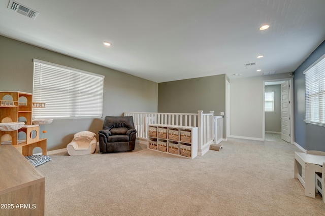 living area featuring carpet, visible vents, and recessed lighting