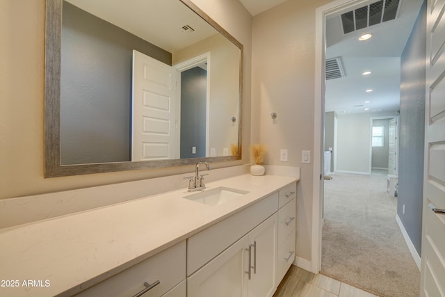 bathroom with visible vents, baseboards, recessed lighting, and vanity