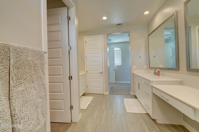 full bathroom with visible vents, baseboards, recessed lighting, and vanity