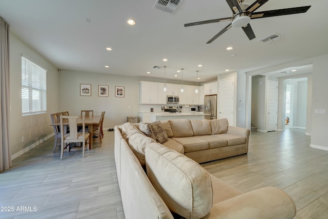 living area featuring visible vents, recessed lighting, and a ceiling fan