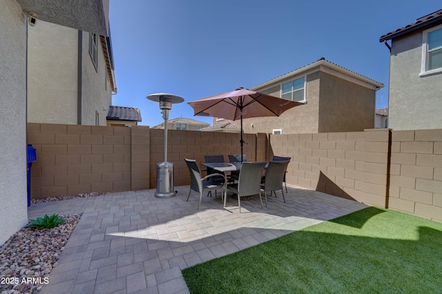 view of patio featuring outdoor dining space and a fenced backyard
