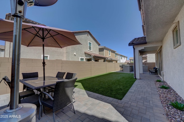 view of patio / terrace featuring outdoor dining space, a residential view, and a fenced backyard