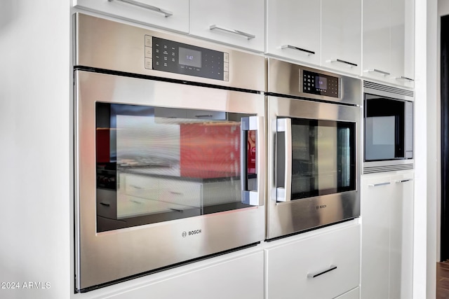 kitchen featuring appliances with stainless steel finishes and white cabinets