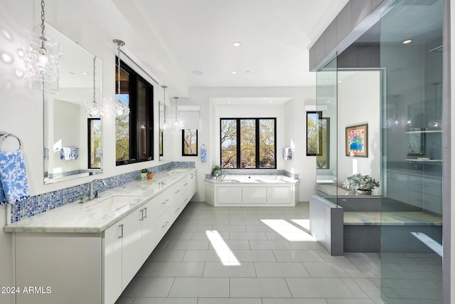 bathroom with vanity, a bath, and tile patterned floors