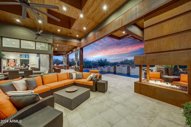 patio terrace at dusk with an outdoor hangout area and ceiling fan