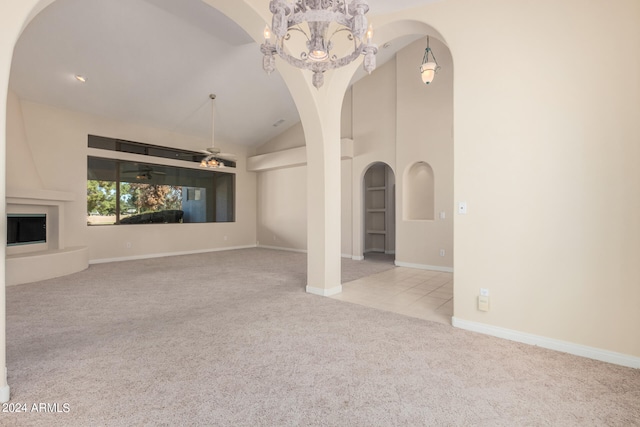 unfurnished living room with light carpet, vaulted ceiling, and a fireplace