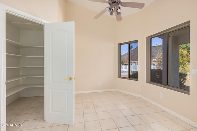 interior space with ceiling fan