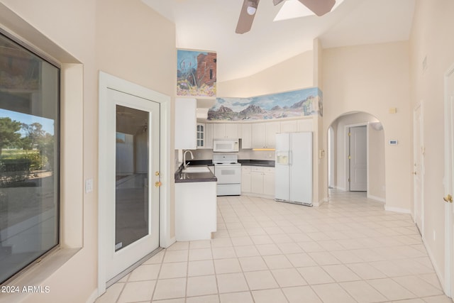 kitchen featuring white appliances, sink, white cabinetry, high vaulted ceiling, and light tile patterned floors