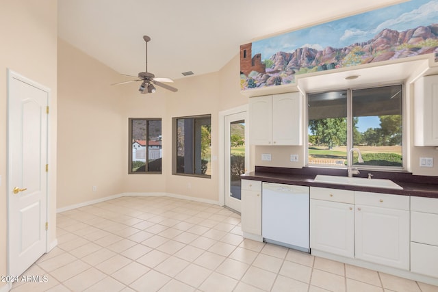 kitchen with white dishwasher, sink, a wealth of natural light, and light tile patterned floors