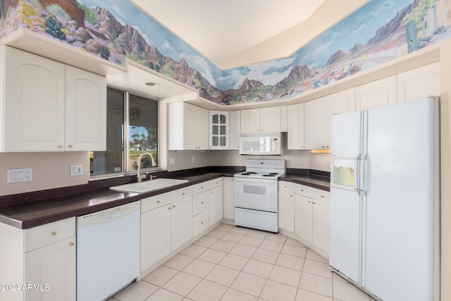 kitchen with lofted ceiling, white cabinets, light tile patterned floors, sink, and white appliances