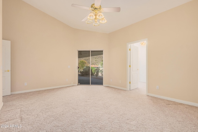 empty room featuring lofted ceiling, light colored carpet, and ceiling fan