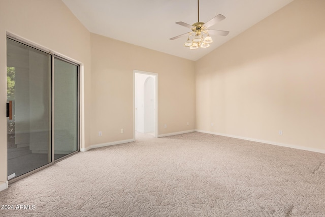 spare room with light carpet, ceiling fan, and vaulted ceiling