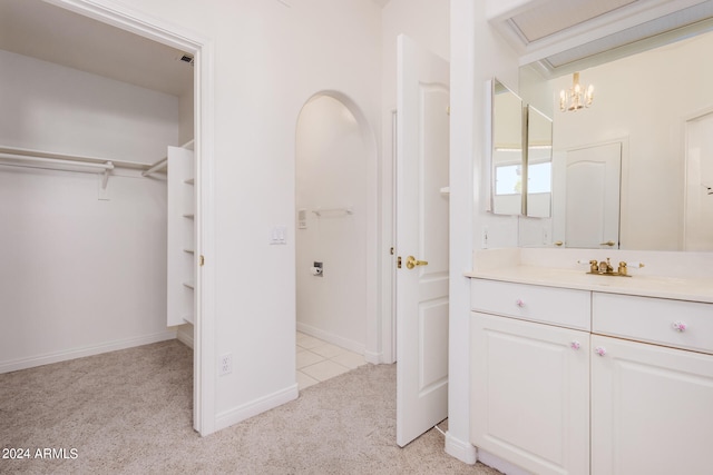 bathroom featuring vanity and a notable chandelier