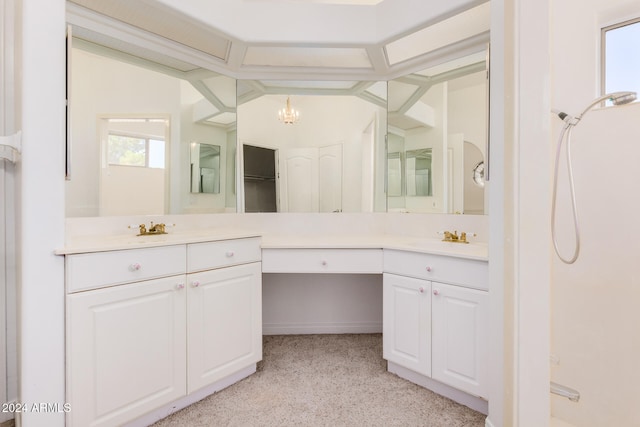 bathroom with vanity, lofted ceiling, and an inviting chandelier