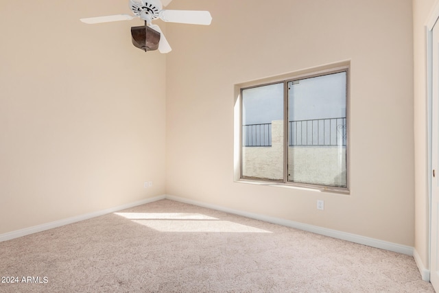 spare room featuring light carpet and ceiling fan