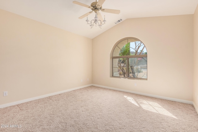 carpeted empty room featuring vaulted ceiling and ceiling fan