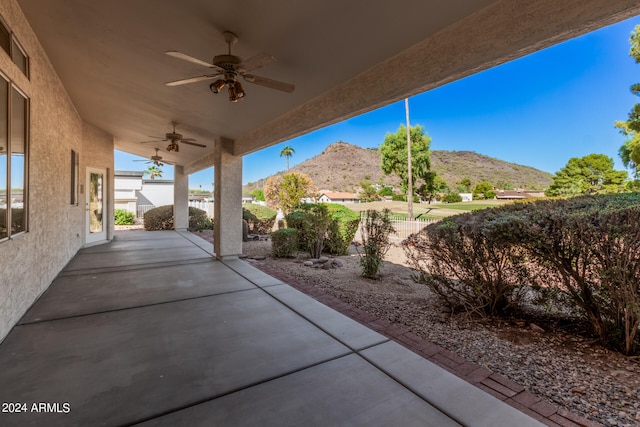 view of patio / terrace with a mountain view and ceiling fan