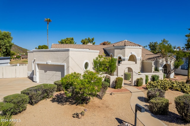 mediterranean / spanish home featuring a garage