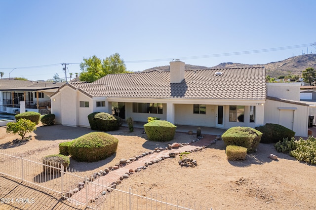 view of front facade featuring a patio area and a mountain view