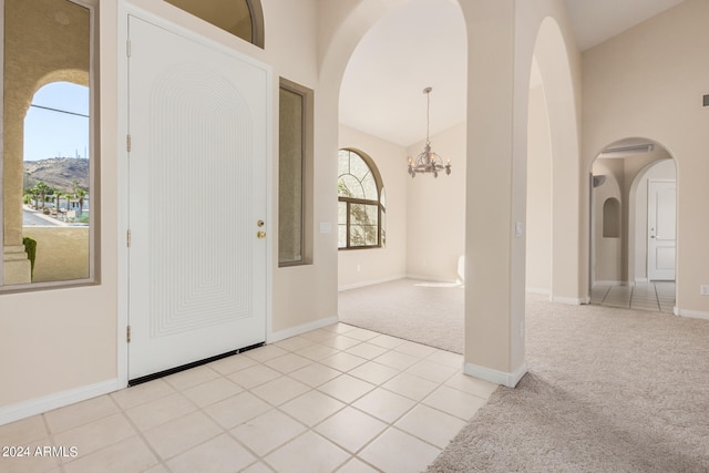 carpeted entryway with a notable chandelier and a mountain view