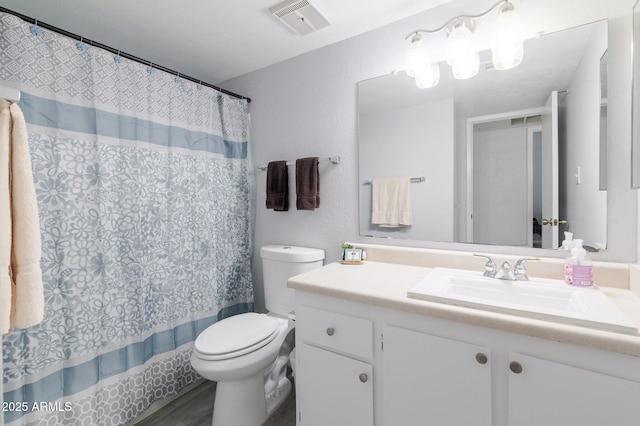 full bath featuring toilet, shower / tub combo, wood finished floors, vanity, and visible vents