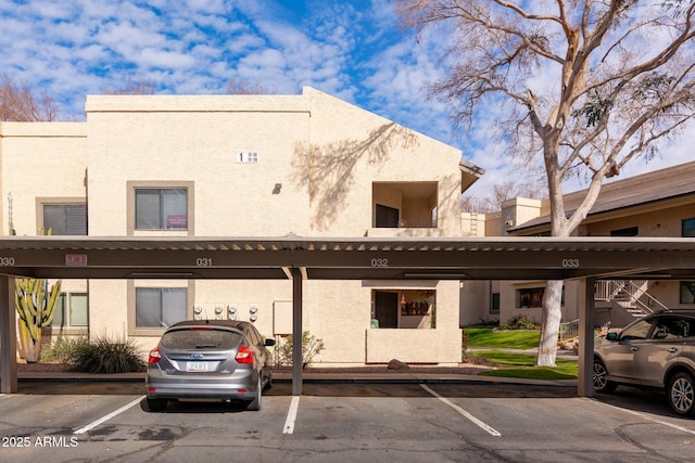 view of building exterior featuring covered parking