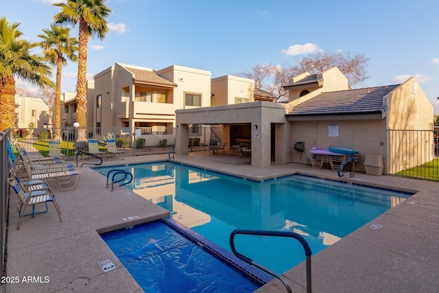 view of pool featuring a hot tub and a patio