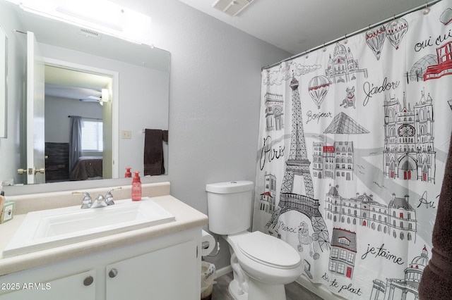 bathroom with vanity, ceiling fan, curtained shower, and toilet