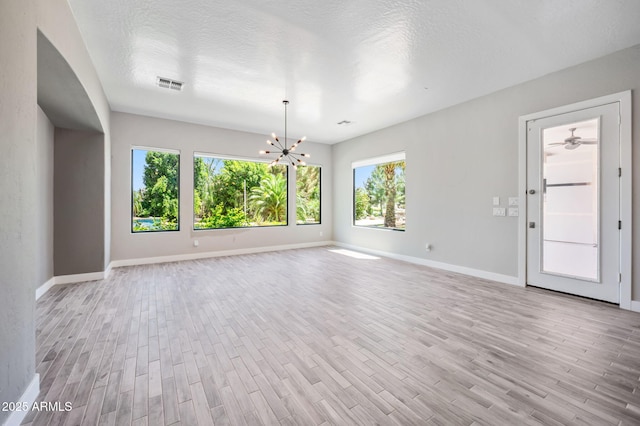 422 E Kaibab Pl, Chandler, AZ 85249 - spare room with healthy amount of natural light, light wood-type flooring, a chandelier, and a textured ceiling