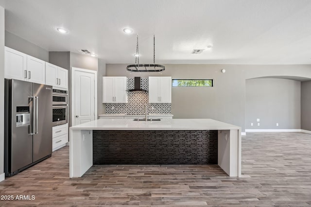 422 E Kaibab Pl, Chandler, AZ 85249 - kitchen featuring appliances with stainless steel finishes, wall chimney range hood, light wood-style floors, light countertops, and recessed lighting